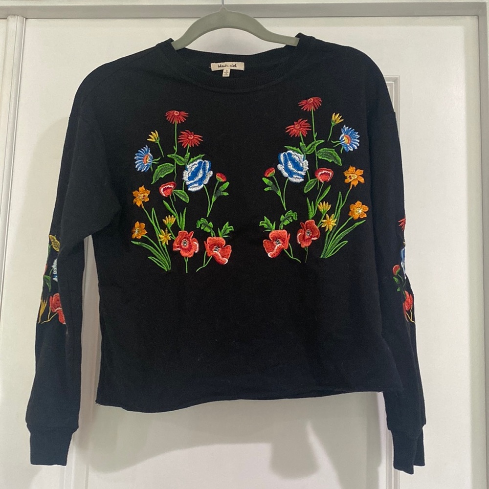 Black long sleeved crop-top with floral embroidery.